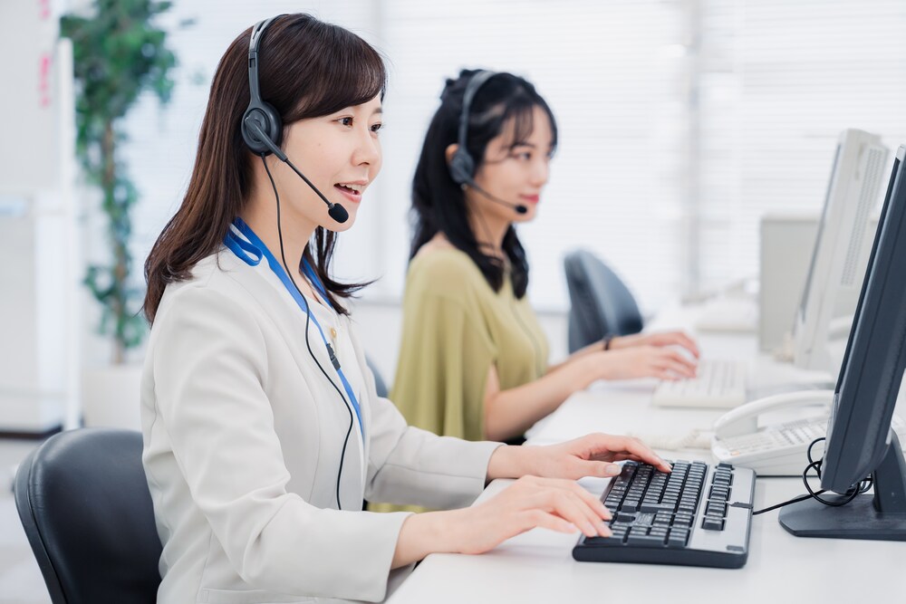 A woman talking to a customer at a call center