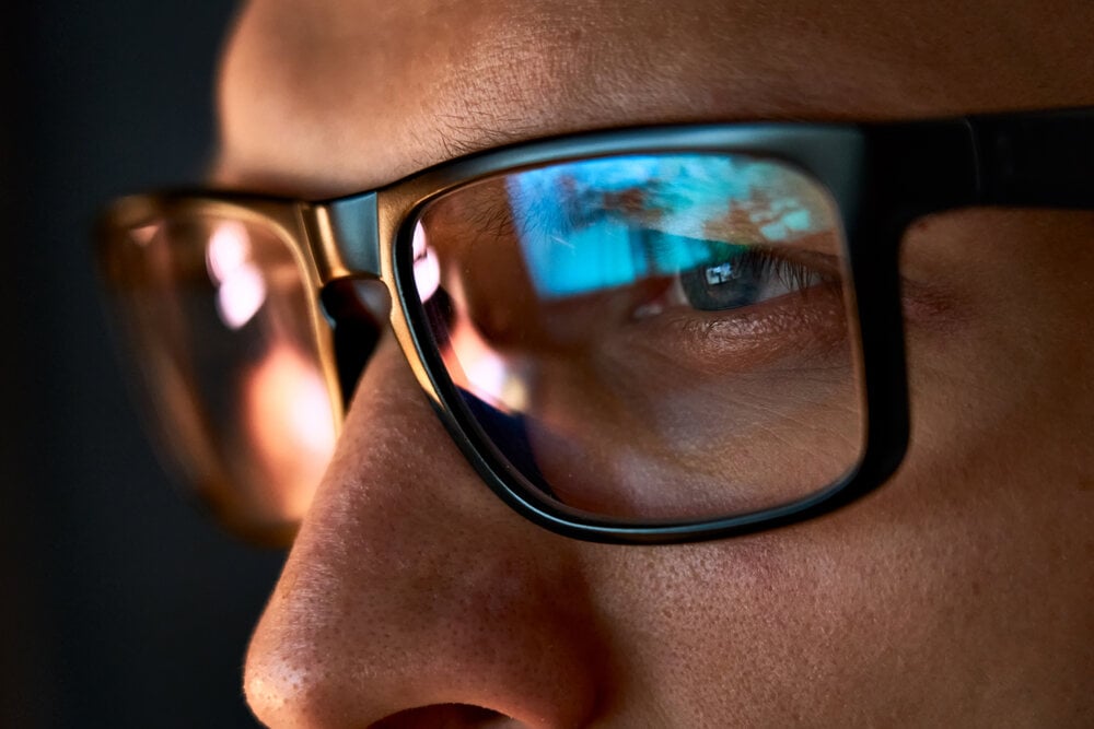 Close-up of a content moderator wearing glasses