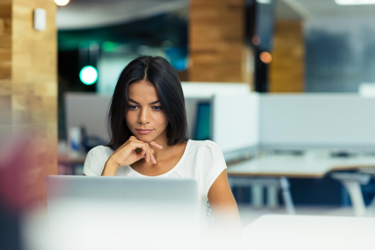 A young woman viewing content on her laptop