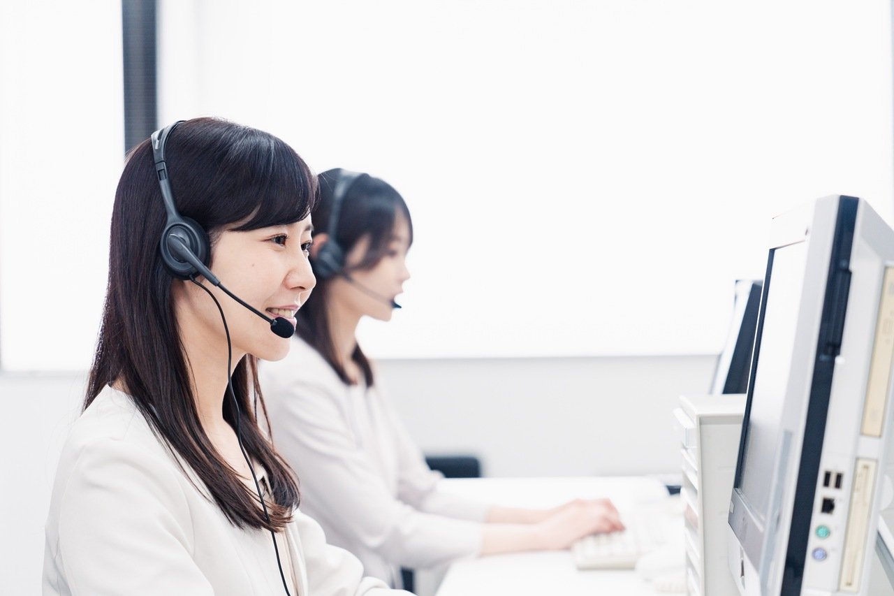 A woman talking to a customer at a call center