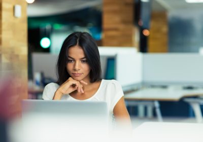 A young woman viewing content on her laptop