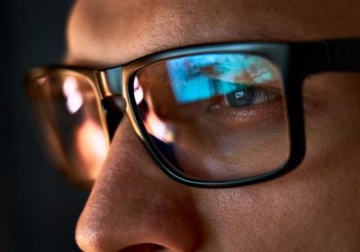 Close-up of a content moderator wearing glasses